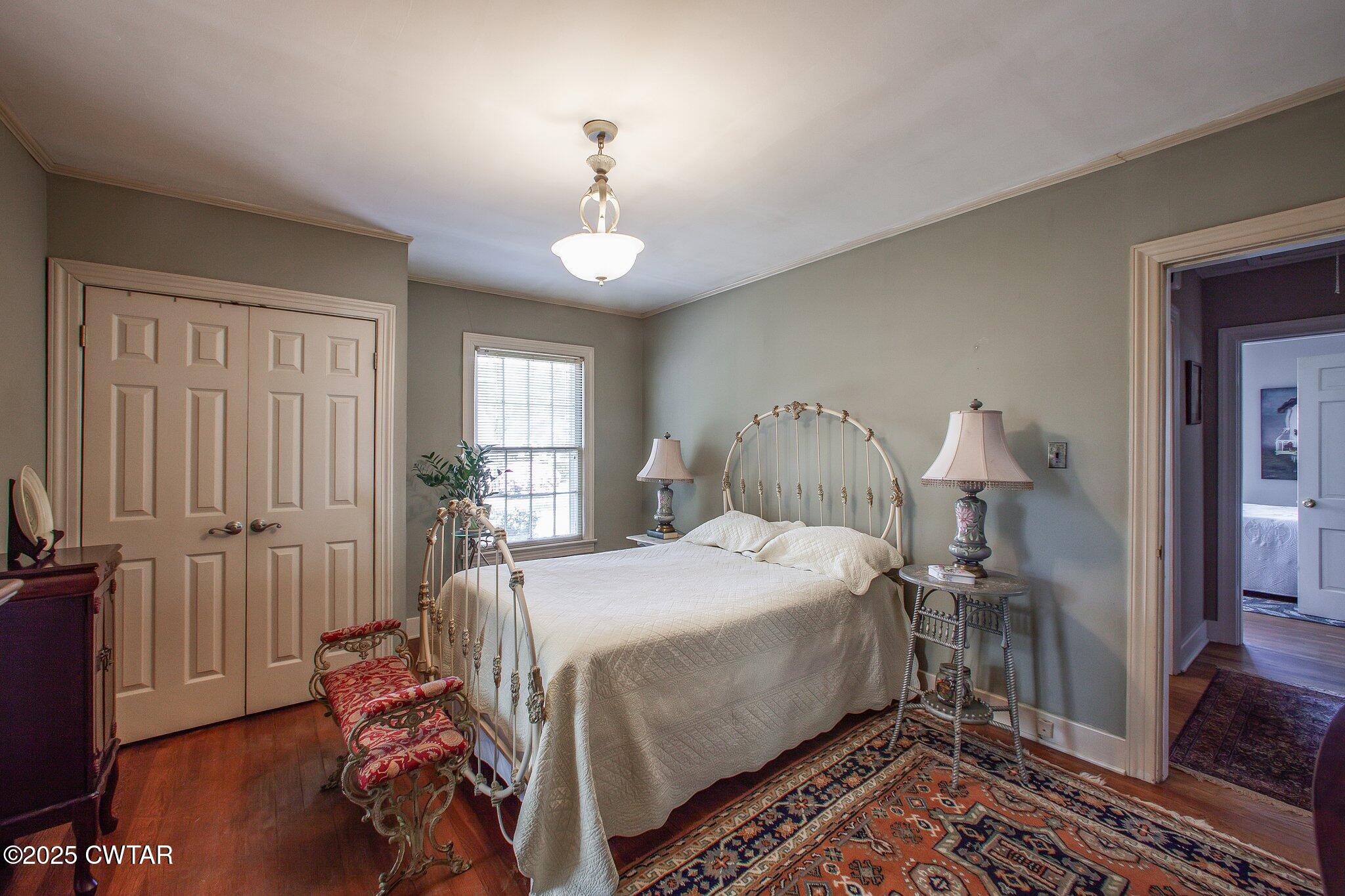 302 Walnut Street Jackson, TN 38301 - Photo 16 of 38 a bedroom with a bed and wooden floor