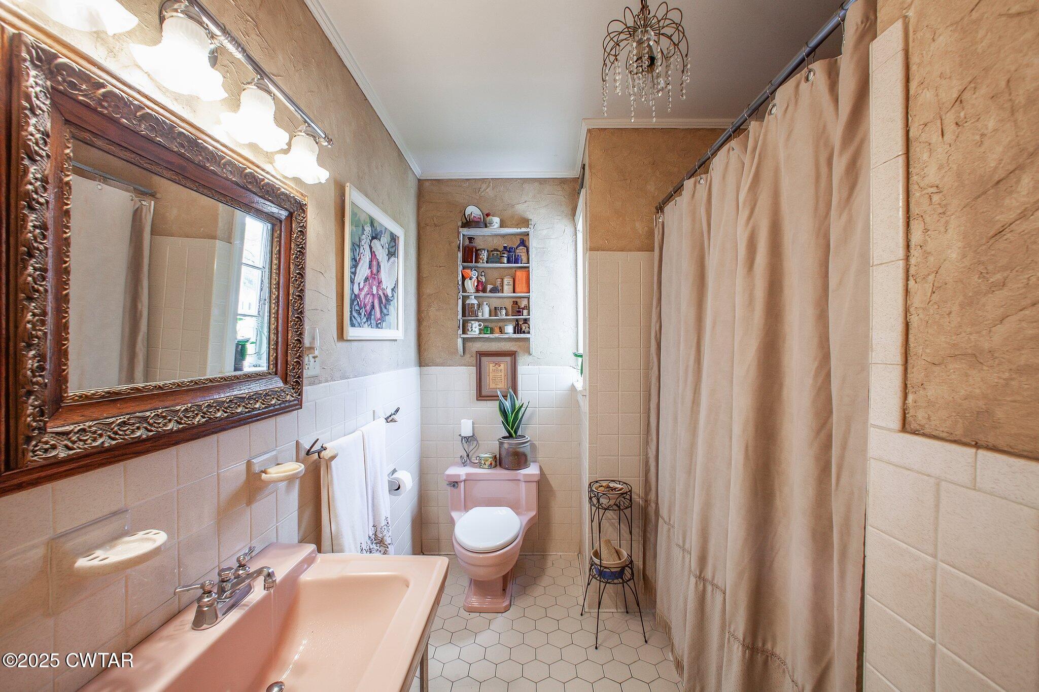 302 Walnut Street Jackson, TN 38301 - Photo 18 of 38 a bathroom with a sink a toilet and shower curtain