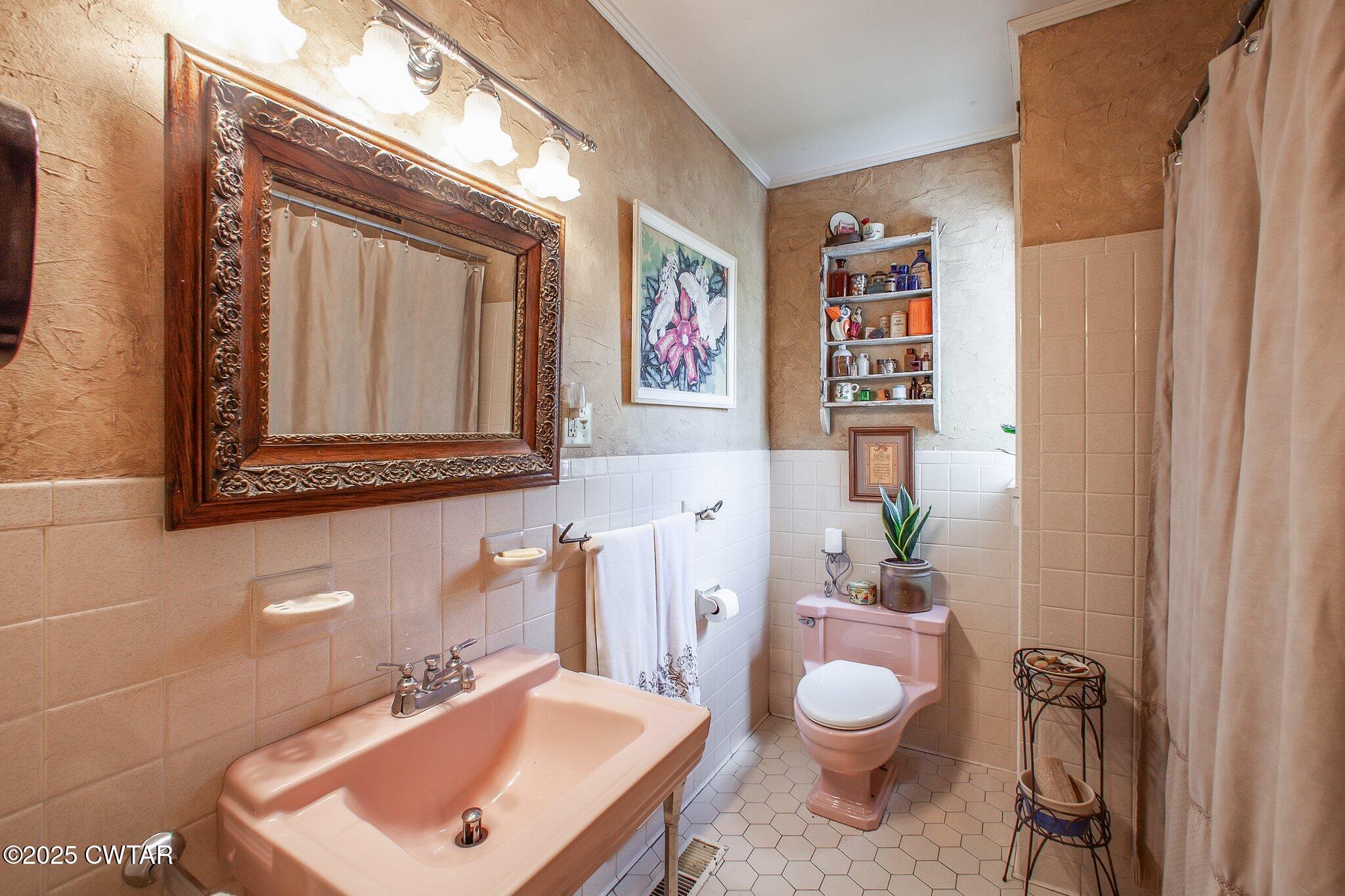 302 Walnut Street Jackson, TN 38301 - Photo 19 of 38 a bathroom with a toilet sink and mirror