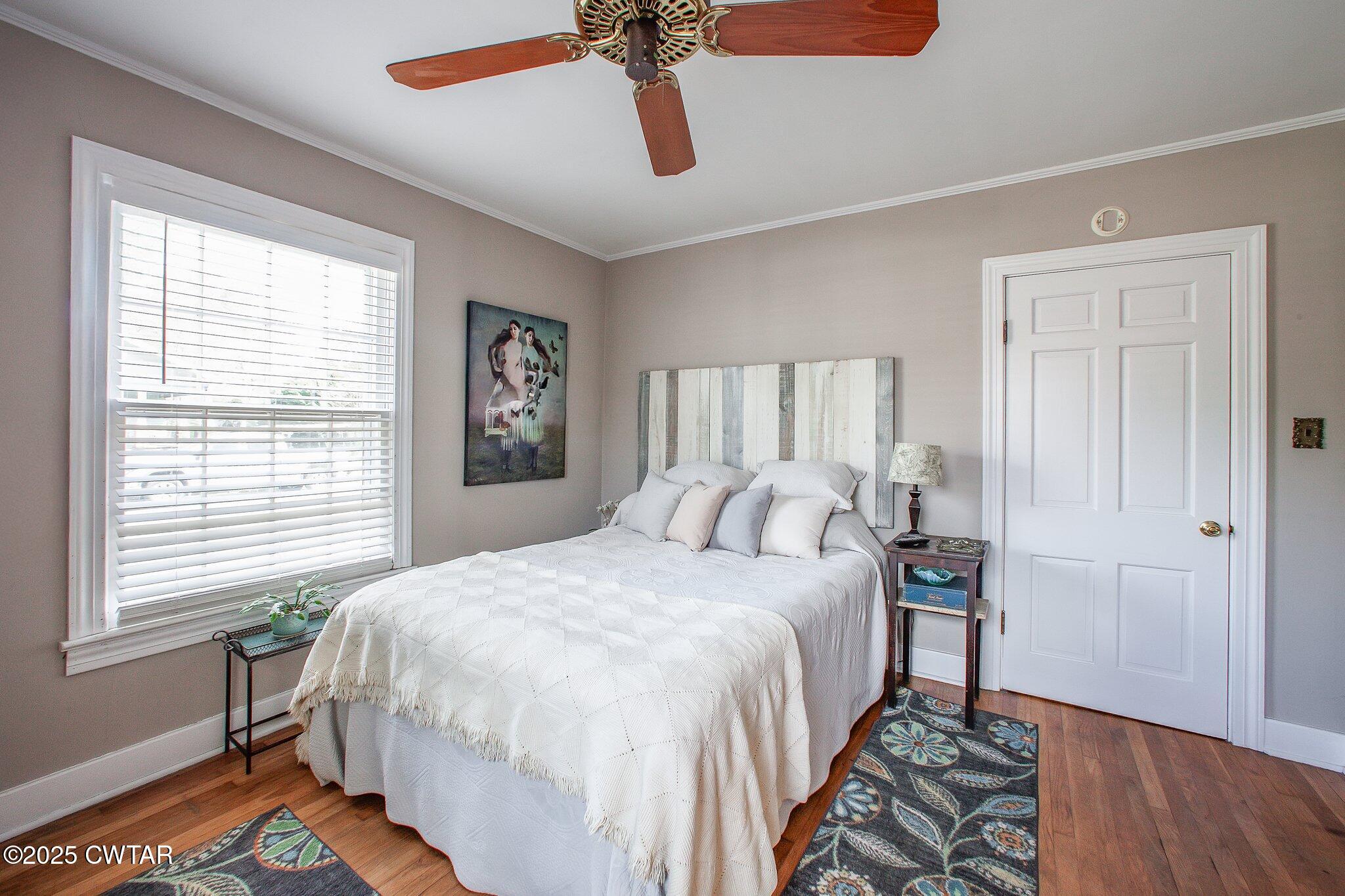 302 Walnut Street Jackson, TN 38301 - Photo 22 of 38 a bedroom with a bed and wooden floor