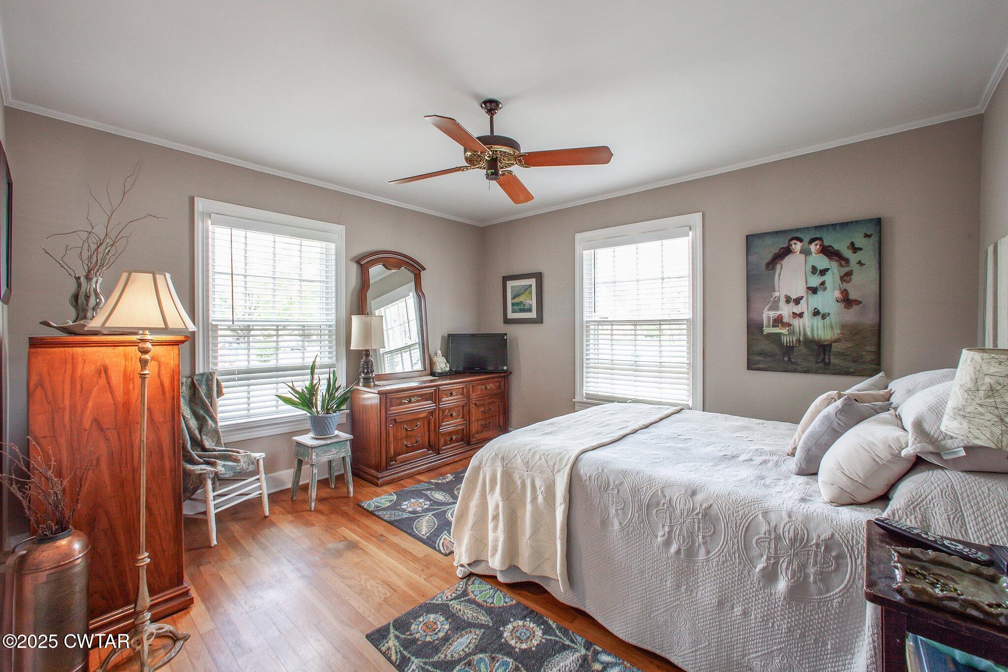 302 Walnut Street Jackson, TN 38301 - Photo 23 of 38 a bedroom with a bed and wooden floor