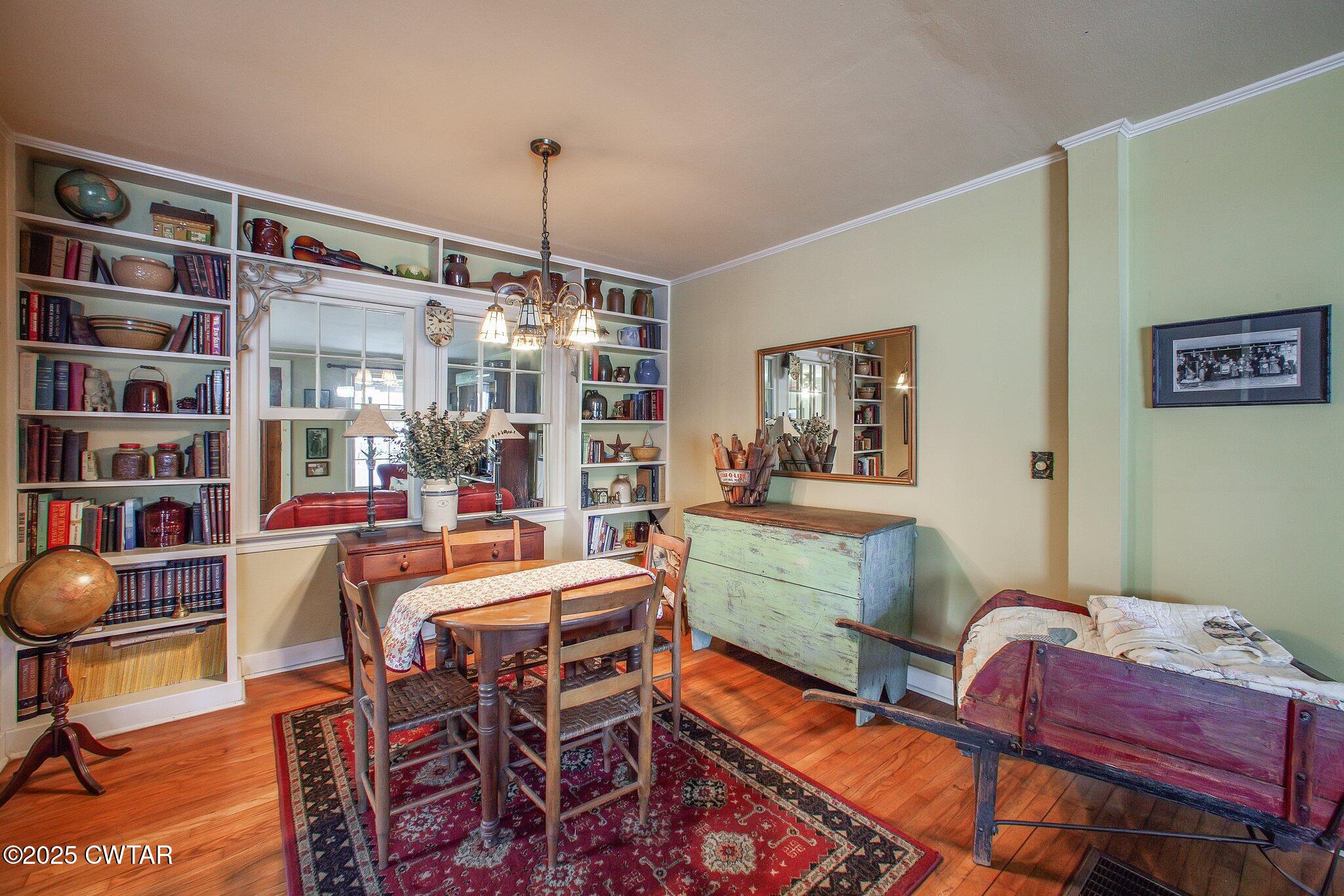 302 Walnut Street Jackson, TN 38301 - Photo 28 of 38 a view of a dining room with furniture and a bookshelf