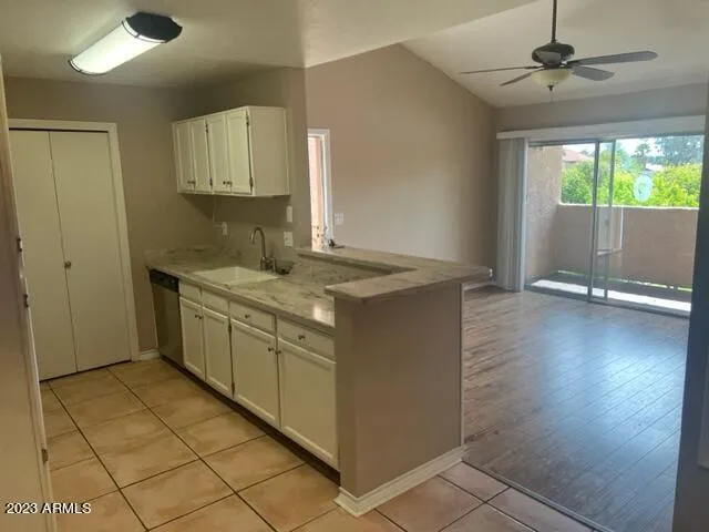 a kitchen with a sink window and cabinets