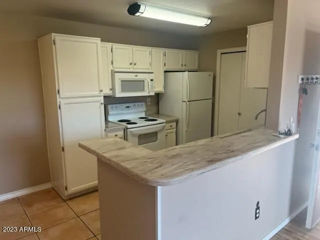 a kitchen with stainless steel appliances granite countertop a refrigerator a stove a sink and a refrigerator