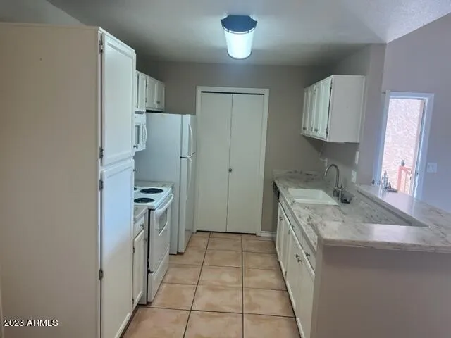 a kitchen with a sink stove and refrigerator