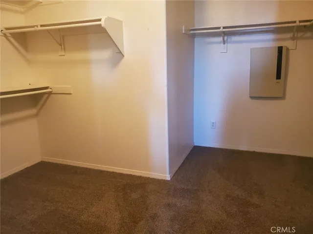 an empty room with windows and fireplace