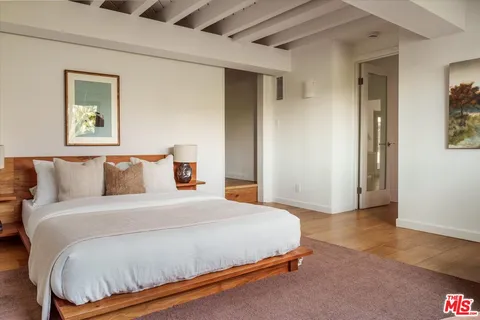 a bedroom with a bed and a night stand