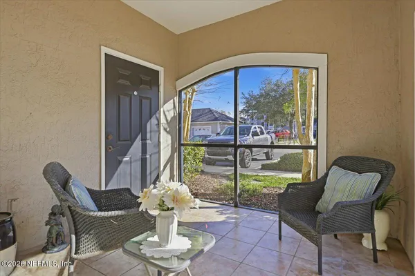 a living room with furniture and a floor to ceiling window