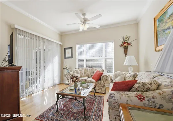 a living room with furniture and a large window
