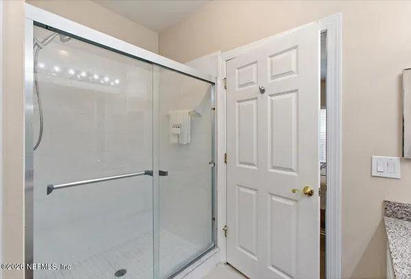 a bathroom with a glass shower door