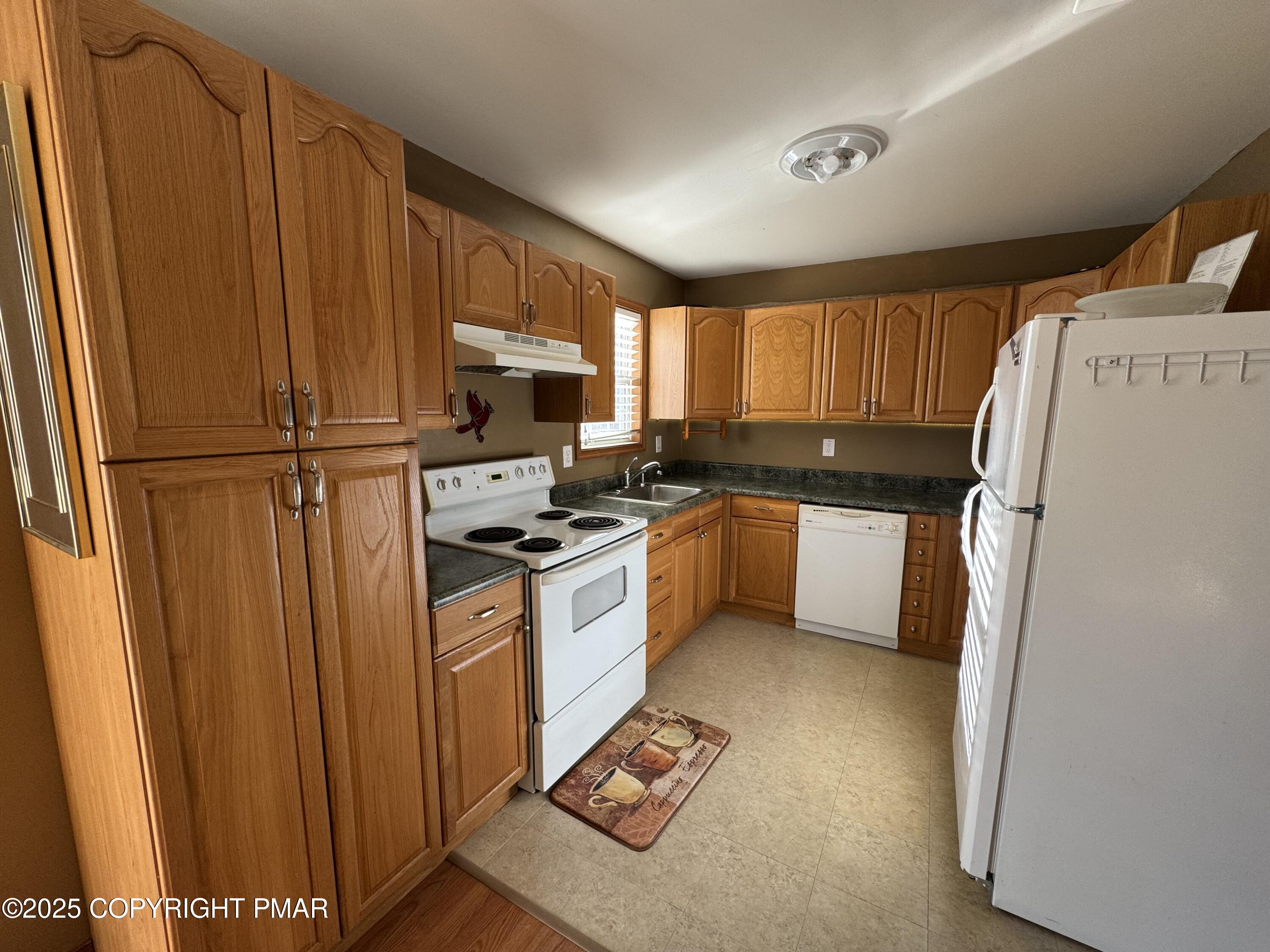 152 Bull Run Long Pond, PA 18334 - Photo 18 of 58 a kitchen with stainless steel appliances a refrigerator a sink a stove a microwave and cabinets