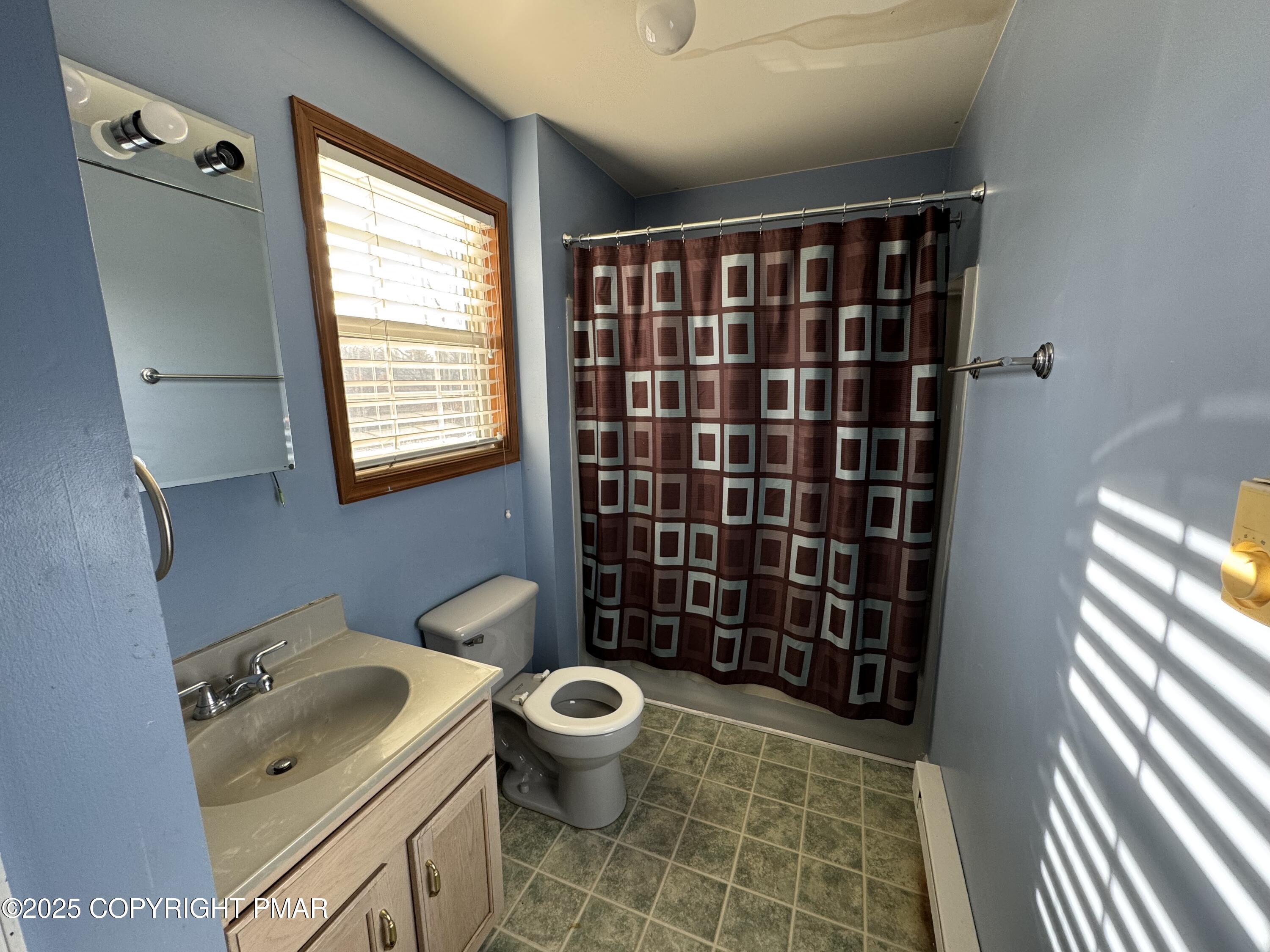 152 Bull Run Long Pond, PA 18334 - Photo 23 of 58 a bathroom with a sink a toilet a shower and a window