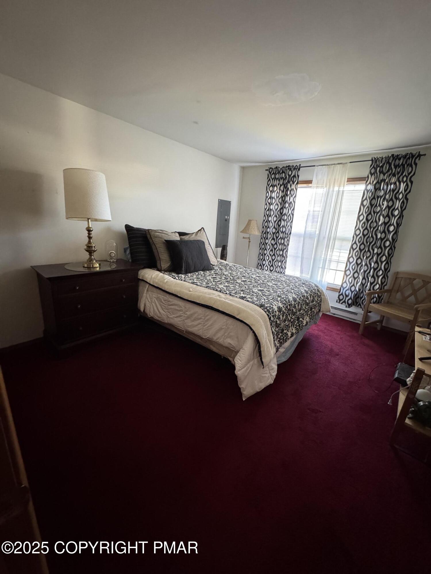 152 Bull Run Long Pond, PA 18334 - Photo 46 of 58 a spacious bedroom with a bed lamp on desk and a window