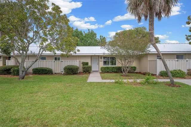 a view of a house with a yard and a patio