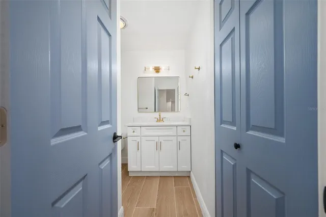a bathroom with a sink a mirror and a vanity