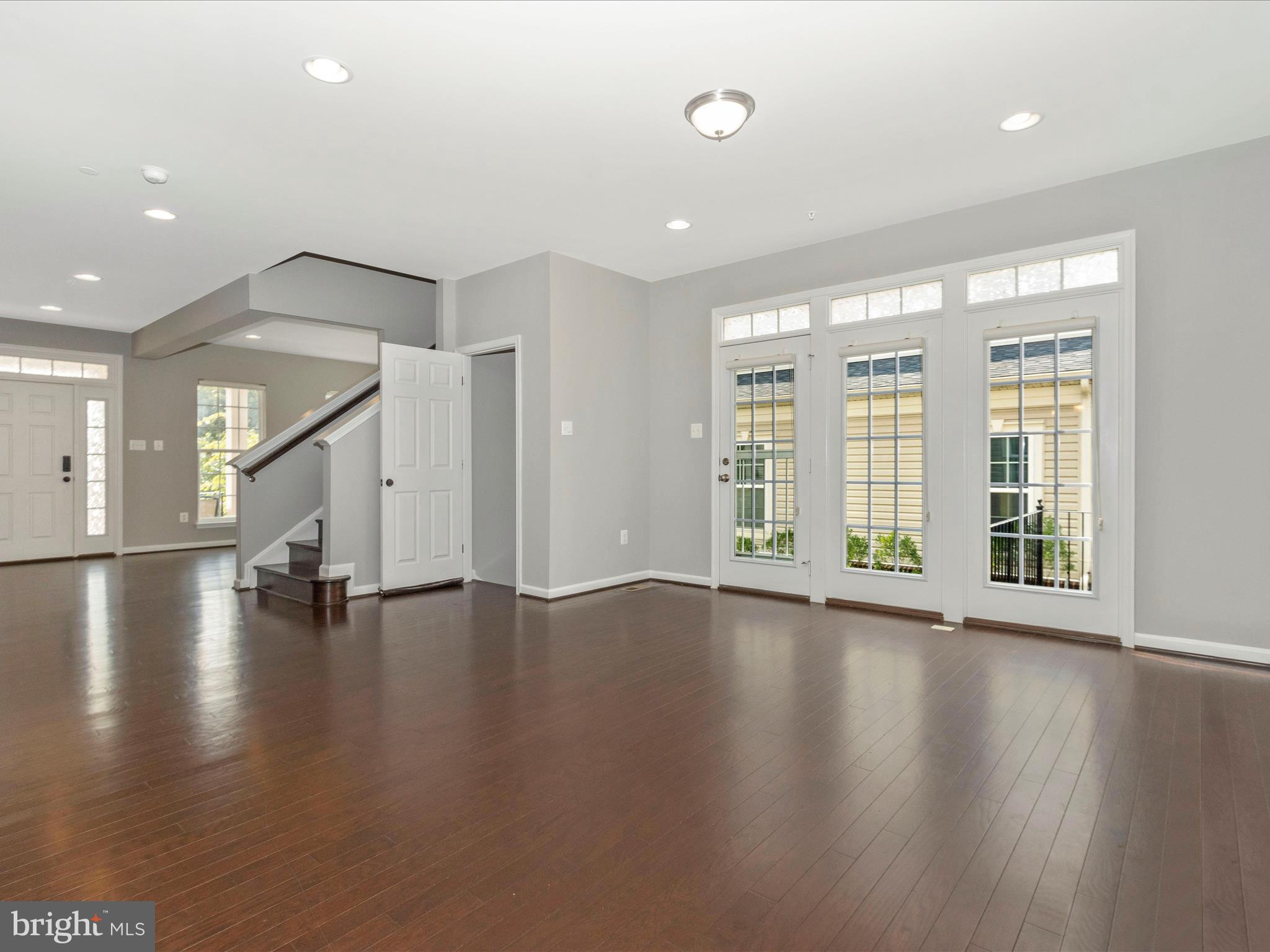 7208 Maisson Ridge Circle Beltsville, MD 20705 - Photo 11 of 53 a view of an empty room with wooden floor and a window