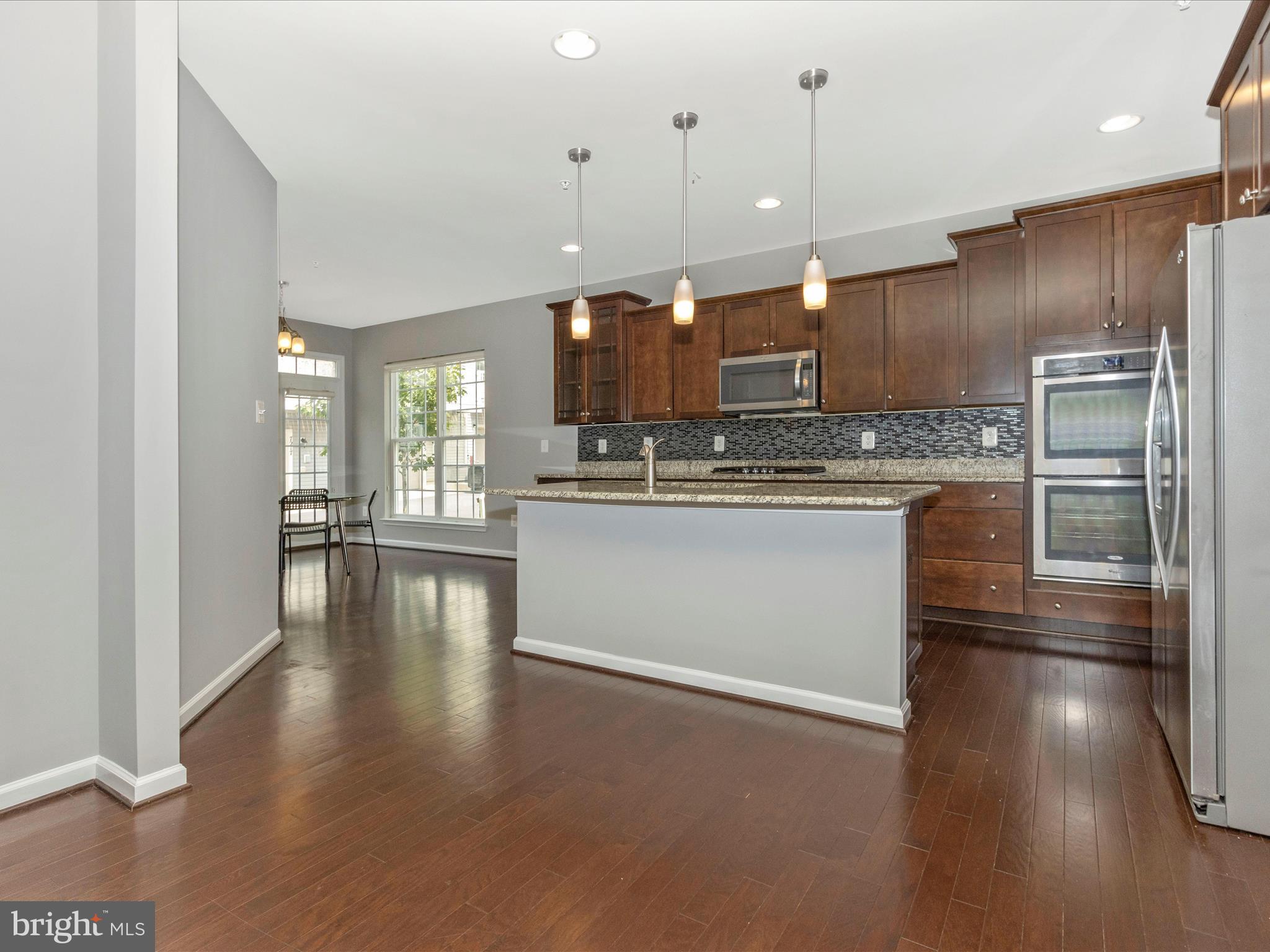7208 Maisson Ridge Circle Beltsville, MD 20705 - Photo 12 of 53 a kitchen with stainless steel appliances granite countertop a refrigerator a stove and a sink with granite countertops