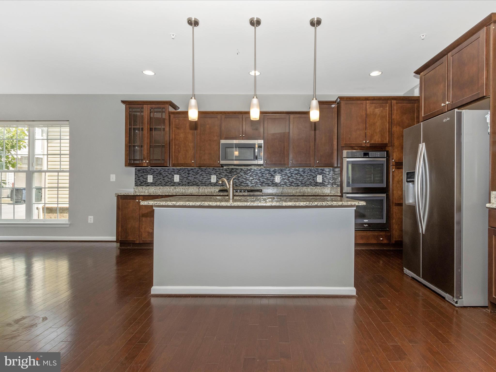 7208 Maisson Ridge Circle Beltsville, MD 20705 - Photo 13 of 53 a kitchen with kitchen island a counter top space a sink stainless steel appliances and cabinets