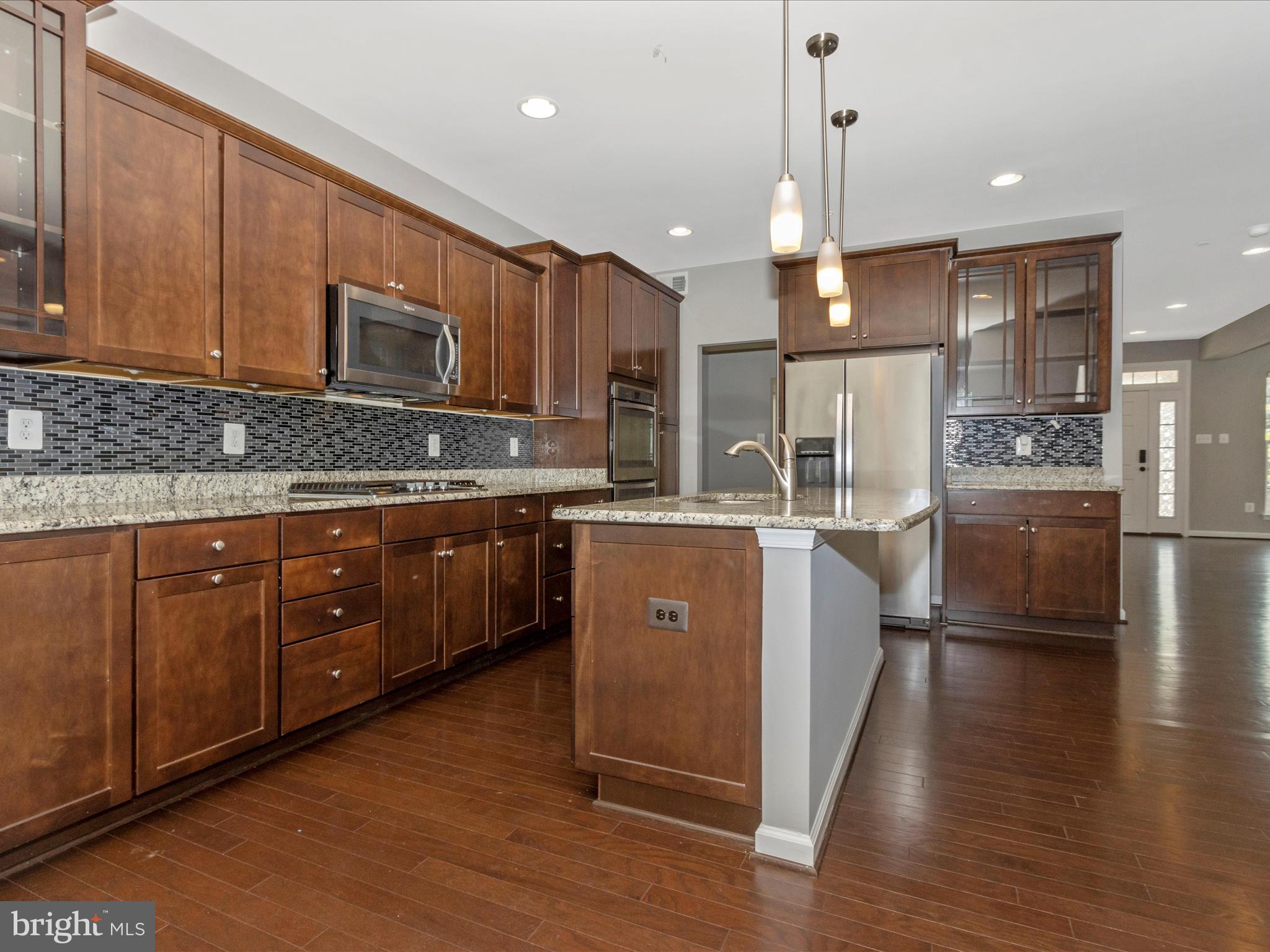 7208 Maisson Ridge Circle Beltsville, MD 20705 - Photo 14 of 53 a kitchen with a sink cabinets and wooden floor