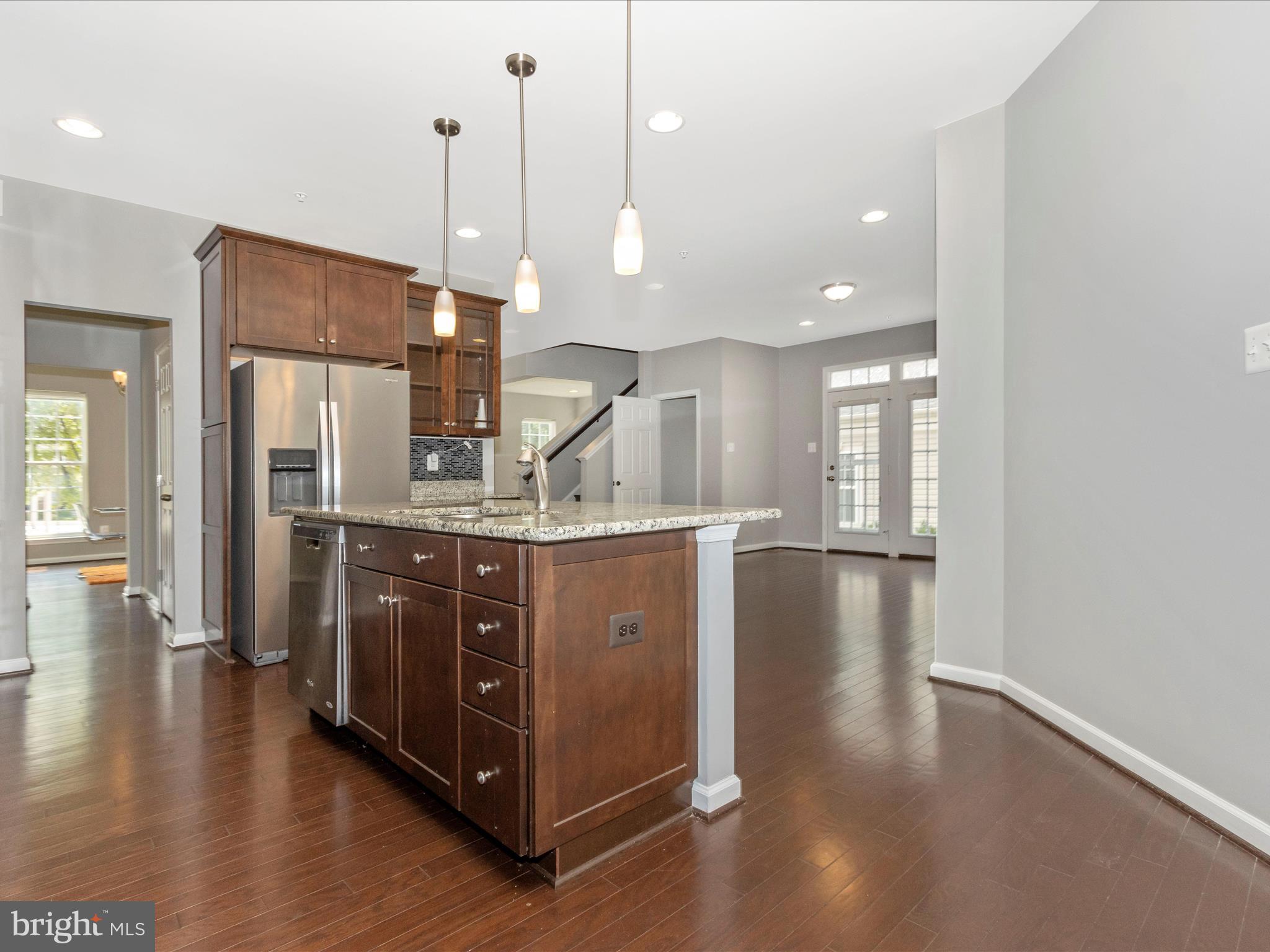 7208 Maisson Ridge Circle Beltsville, MD 20705 - Photo 15 of 53 a kitchen with stainless steel appliances granite countertop a refrigerator a sink and a wooden floor
