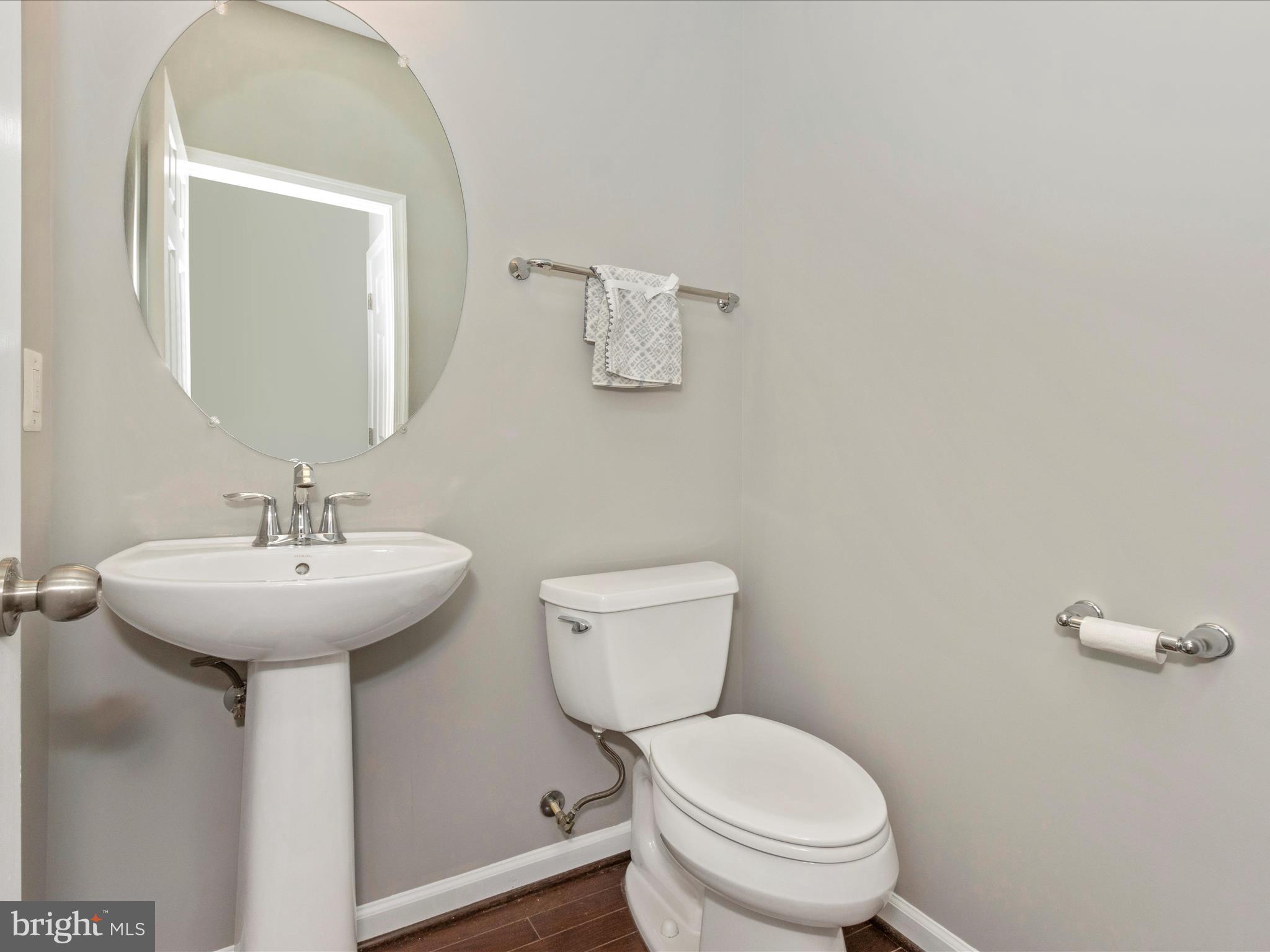 7208 Maisson Ridge Circle Beltsville, MD 20705 - Photo 20 of 53 a bathroom with a toilet a sink and mirror