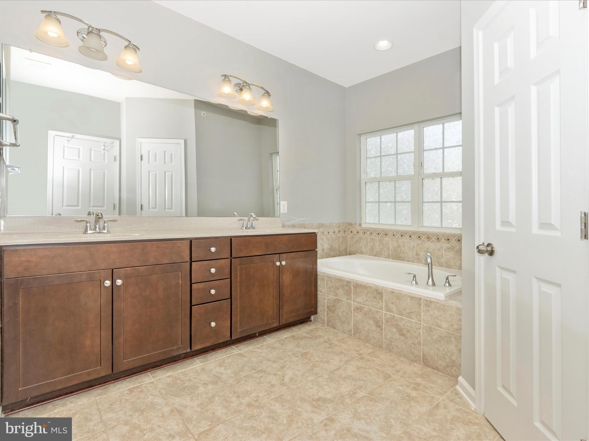 7208 Maisson Ridge Circle Beltsville, MD 20705 - Photo 24 of 53 a spacious bathroom with a tub sink and mirror