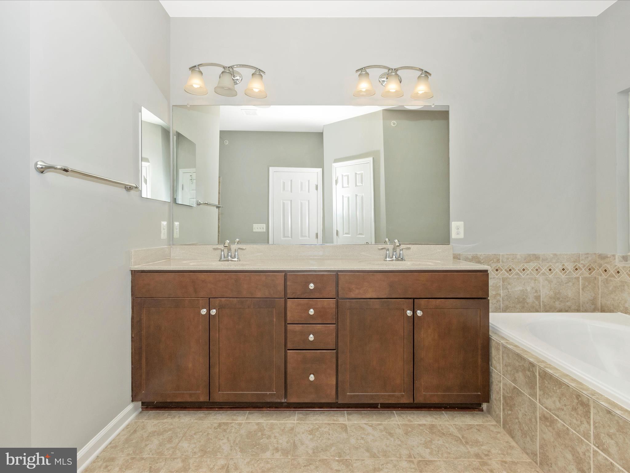 7208 Maisson Ridge Circle Beltsville, MD 20705 - Photo 25 of 53 a bathroom with a sink vanity and mirror