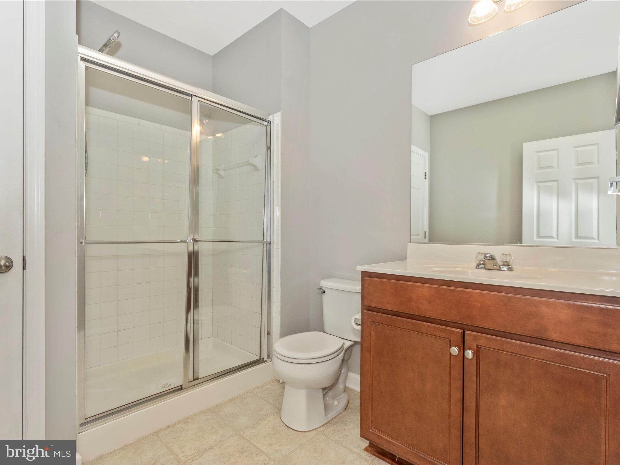 7208 Maisson Ridge Circle Beltsville, MD 20705 - Photo 39 of 53 a bathroom with a granite countertop sink toilet a mirror and shower
