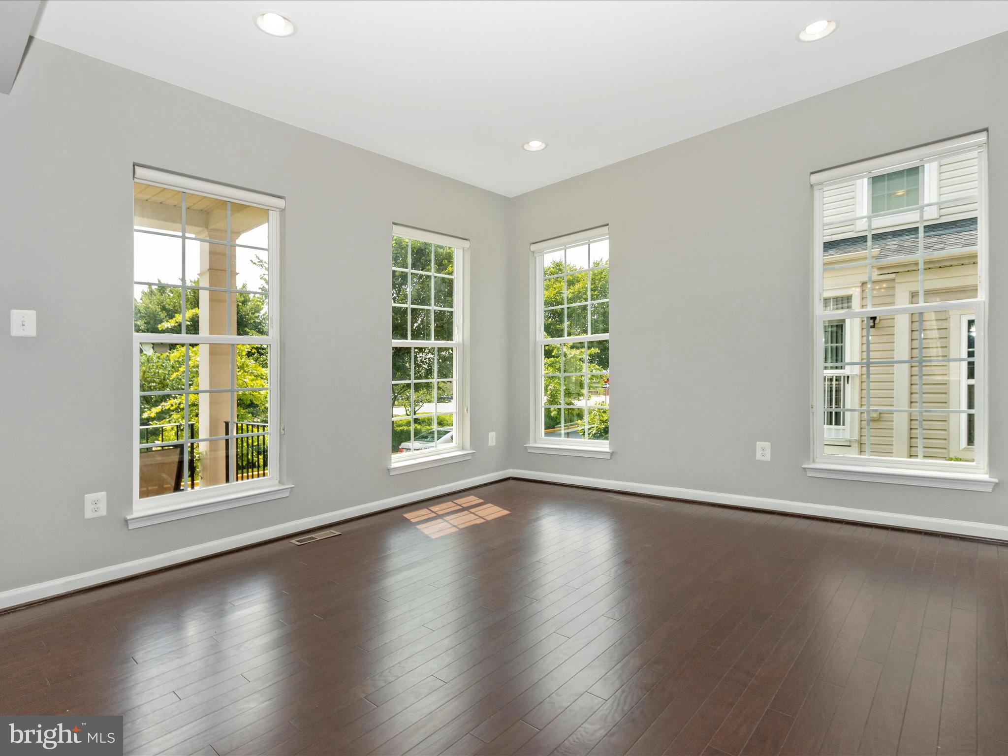 7208 Maisson Ridge Circle Beltsville, MD 20705 - Photo 4 of 53 a view of an empty room with wooden floor and a window