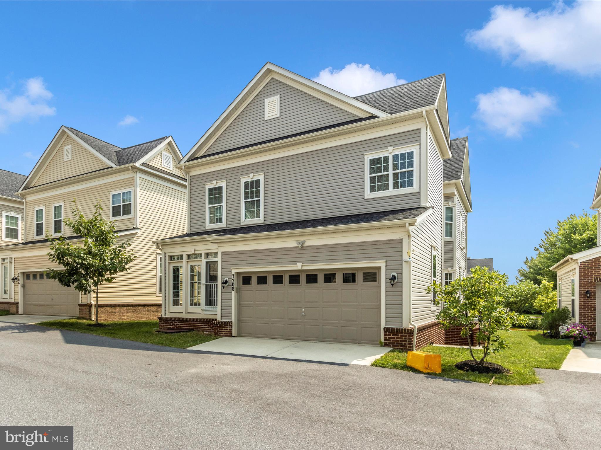 7208 Maisson Ridge Circle Beltsville, MD 20705 - Photo 49 of 53 a front view of a house with a yard and garage
