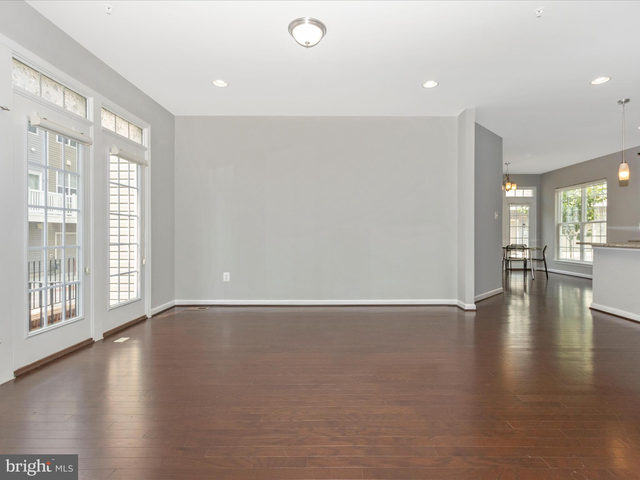 7208 Maisson Ridge Circle Beltsville, MD 20705 - Photo 9 of 53 a view of an empty room with wooden floor and a window