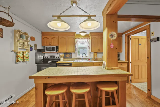 a living room with furniture and a painting on the wall