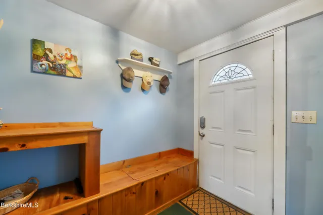 a bedroom with two beds and painting on the wall