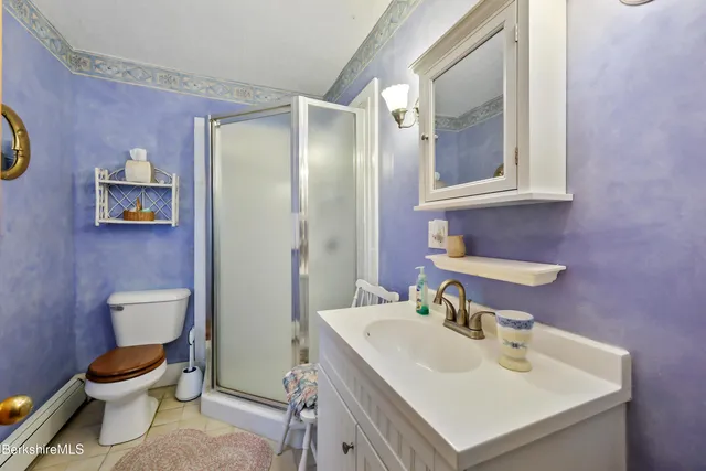 a bedroom with a bed window and chair