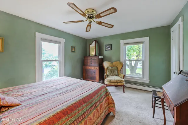 a bathroom with a sink a toilet and shower curtain