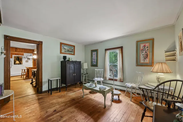 a living room with furniture a window and a flat screen tv