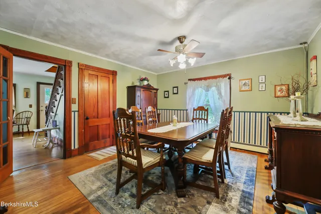 a view of a a dining room with furniture window and wooden floor