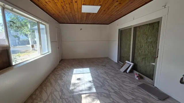 a view of small space with wooden floor and windows