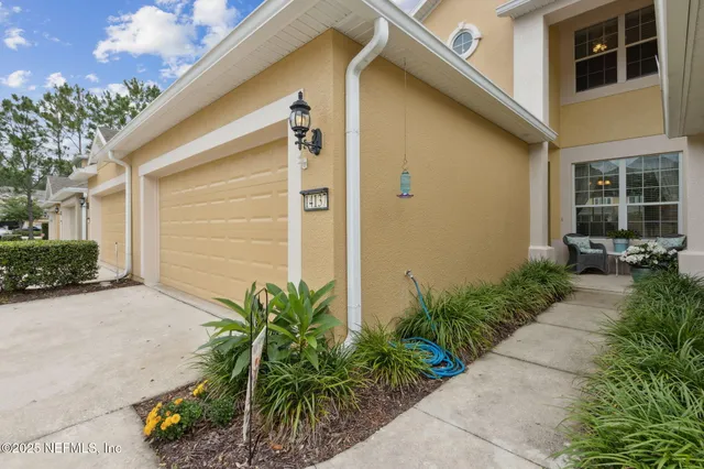 a couple of potted plants in front of door