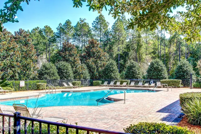 a living room with furniture kitchen view and a large window