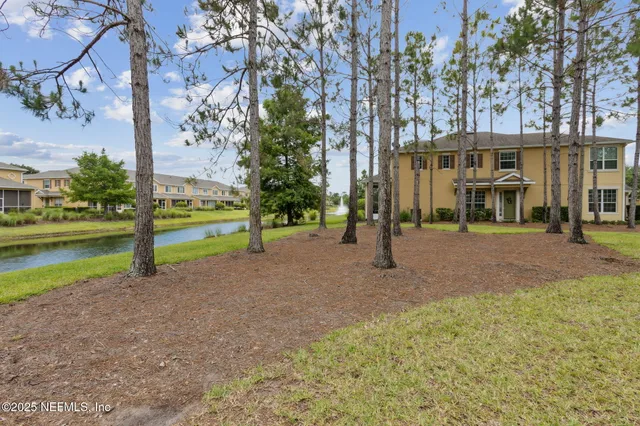 a kitchen with kitchen island granite countertop a sink and a refrigerator
