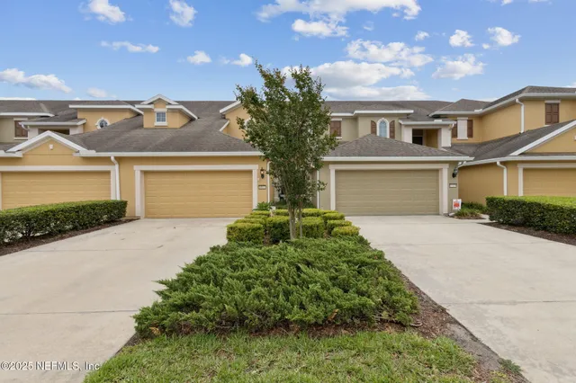 a kitchen with stainless steel appliances a refrigerator a stove a sink a dining table and chairs