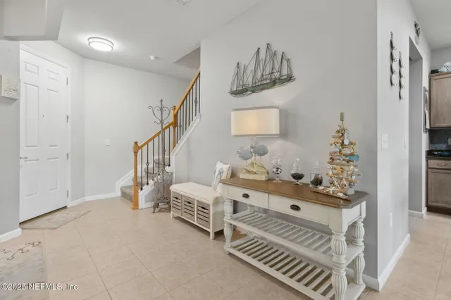 a view of a dining room with furniture a livingroom and chandelier