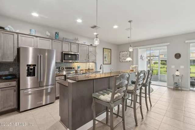 an aerial view of a house with a garden and lake view