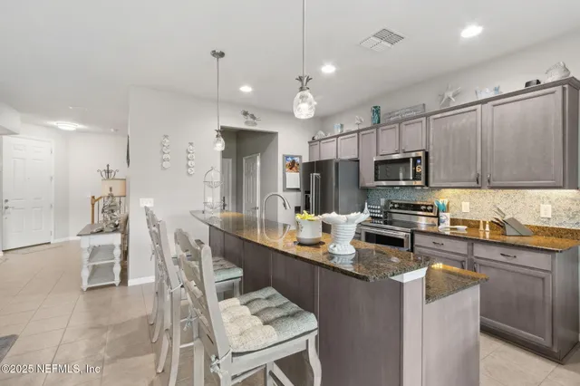 a view of a dining room with furniture and a floor to ceiling window