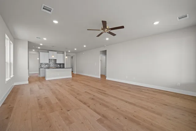 a kitchen with stainless steel appliances granite countertop a sink a stove and a wooden floors