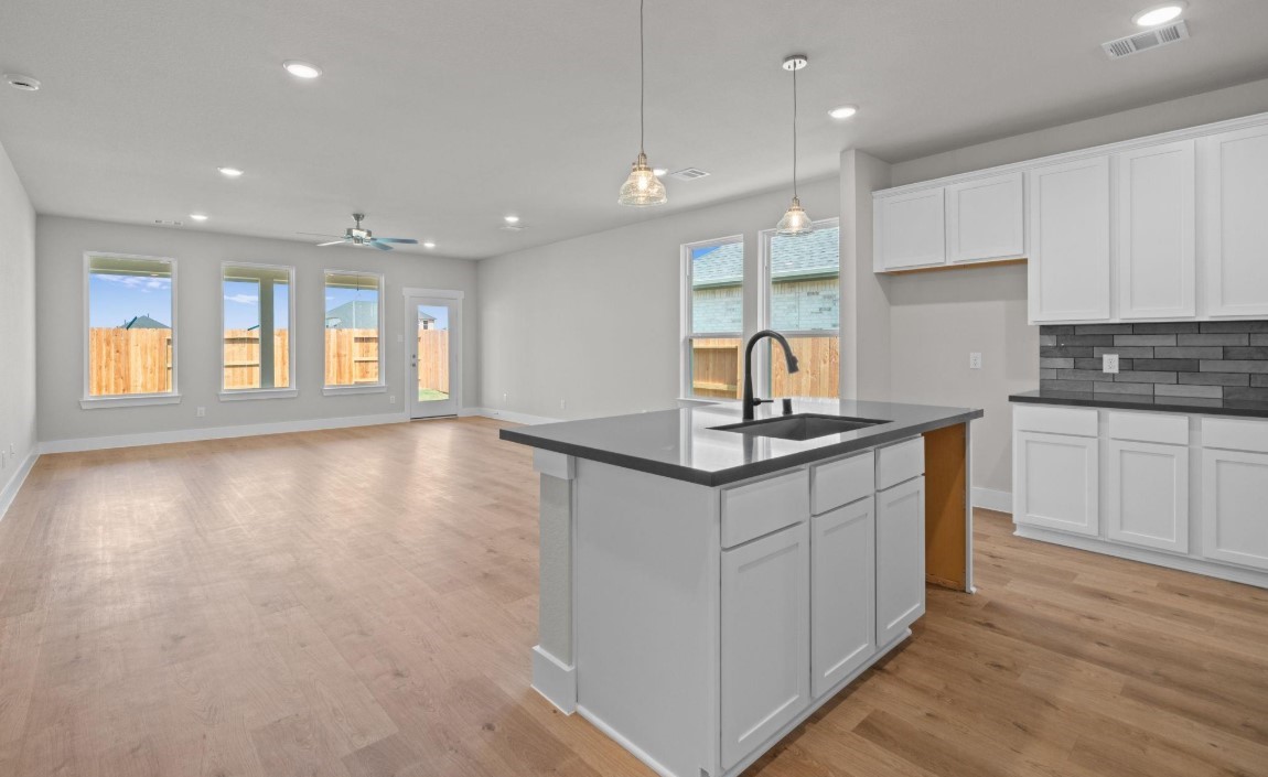 325 Gambels Quail Road Hempstead, TX 77445 - Photo 2 of 21 a kitchen with stainless steel appliances granite countertop a sink a stove and a wooden floors
