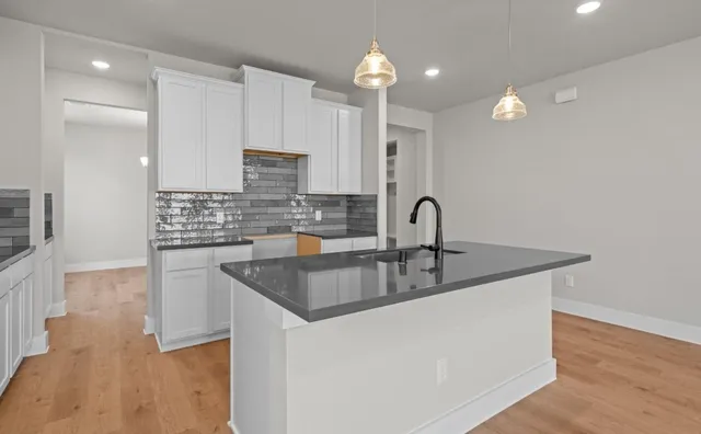 a front view of a house with a garden and plants