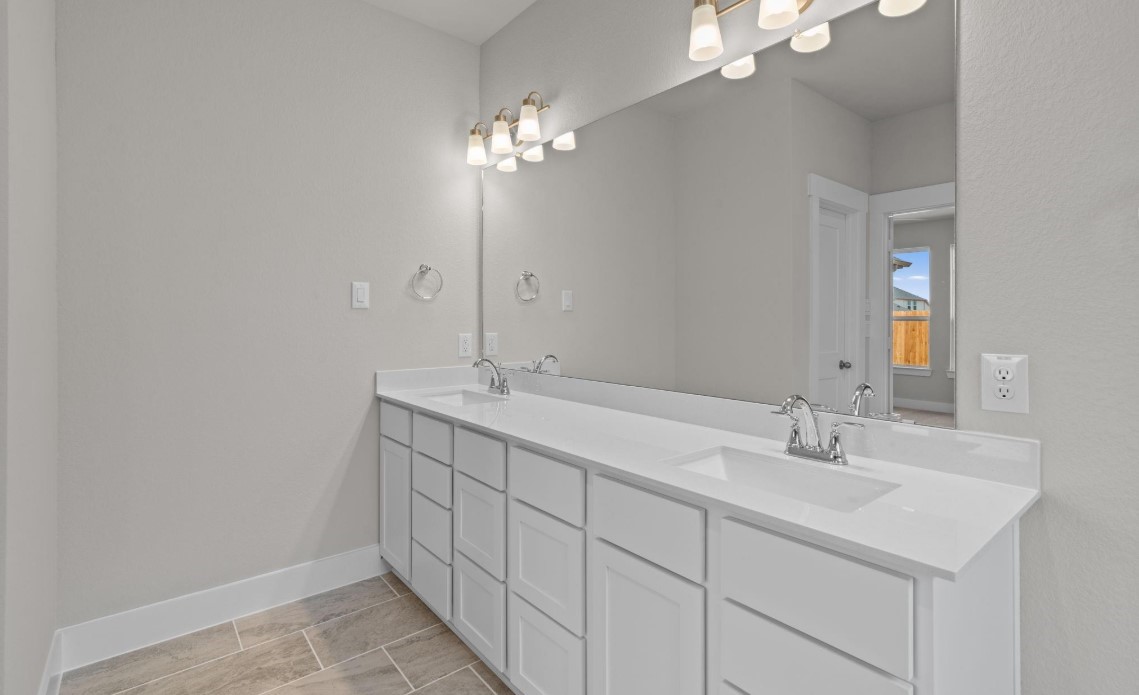 325 Gambels Quail Road Hempstead, TX 77445 - Photo 9 of 21 a bathroom with a double vanity sink and a mirror