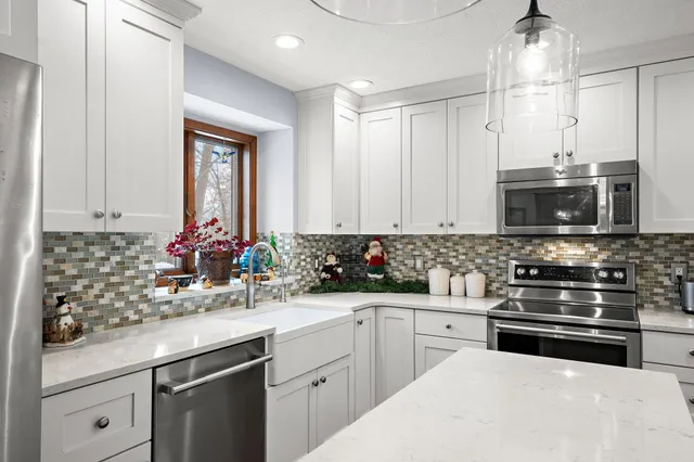 a kitchen with a sink stove and microwave